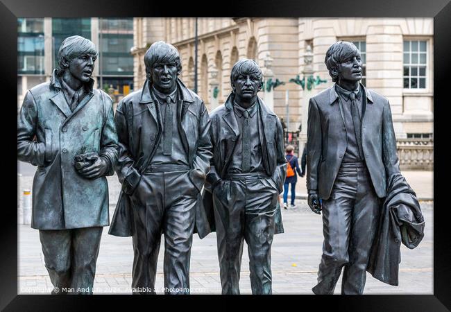 A group of people walking down the street with The Burghers of Calais in the background Framed Print by Man And Life