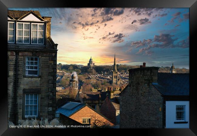 Picturesque sunset over a historic cityscape with silhouetted buildings and dramatic clouds in Lancaster. Framed Print by Man And Life