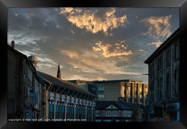 Dramatic sunset over a quaint town street with historic buildings and a vibrant sky with golden clouds in Lancaster. Framed Print by Man And Life