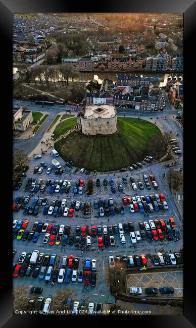 Aerial view of a circular building surrounded by a parking lot with cars during twilight in York, North Yorkshire Framed Print by Man And Life