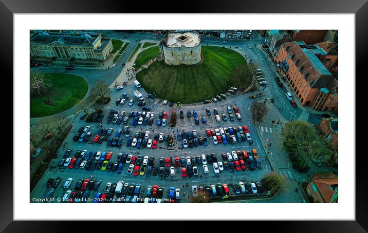 Aerial view of a circular building surrounded by a parking lot with colorful cars, showcasing urban planning and architecture in York, North Yorkshire Framed Mounted Print by Man And Life