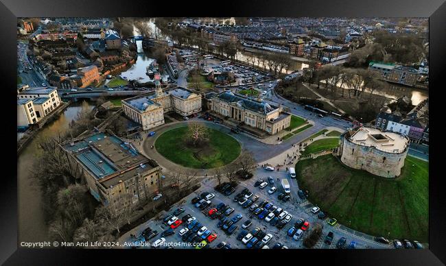 Aerial view of a historic castle with surrounding park and adjacent parking lot in an urban setting at dusk in York, North Yorkshire Framed Print by Man And Life