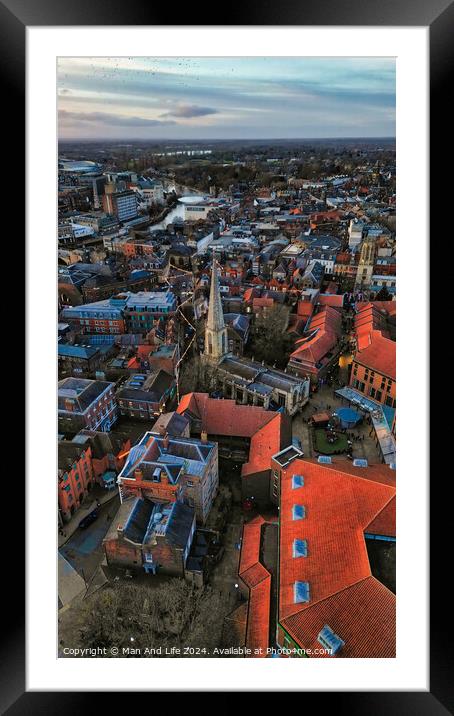 Aerial view of a historic town at dusk with prominent church spire and terracotta rooftops against a moody sky in York, North Yorkshire Framed Mounted Print by Man And Life
