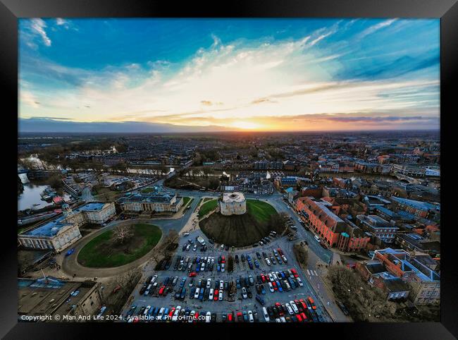 Aerial view of a cityscape at sunset with vibrant skies and parking lot in the foreground in York, North Yorkshire Framed Print by Man And Life