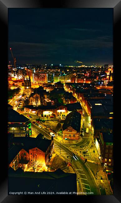 Aerial night view of a cityscape with illuminated streets and buildings, showcasing urban architecture in Leeds, UK. Framed Print by Man And Life