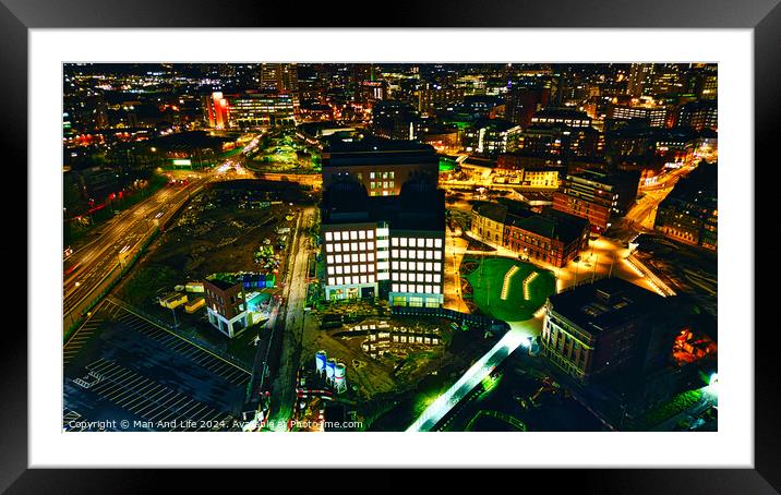 Aerial night view of an illuminated urban office building amidst city lights in Leeds, UK. Framed Mounted Print by Man And Life
