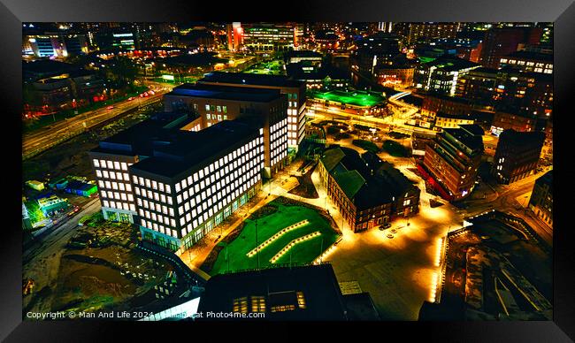 Aerial night view of an illuminated urban landscape with buildings and streets in Leeds, UK. Framed Print by Man And Life