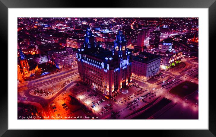 Aerial night view of an illuminated historic building in an urban cityscape in Liverpool, UK. Framed Mounted Print by Man And Life