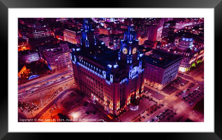 Aerial night view of an illuminated historic building in an urban setting with city lights in Liverpool, UK. Framed Mounted Print by Man And Life