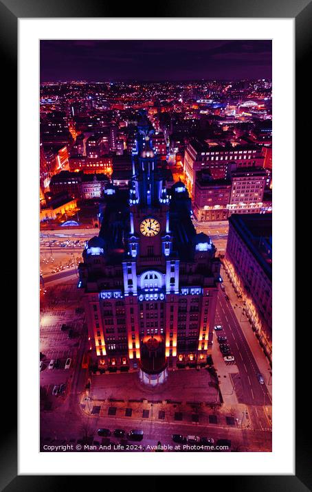 Vertical aerial view of a lit-up cityscape at night with a prominent clock tower and urban streets in Liverpool, UK. Framed Mounted Print by Man And Life