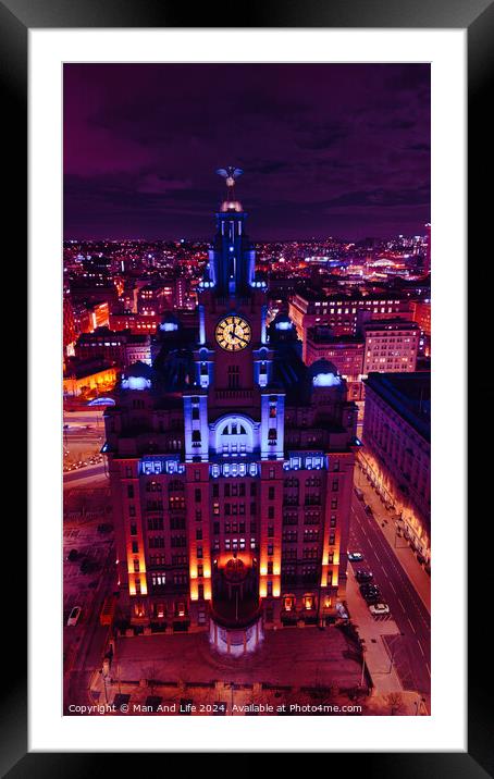 Vertical aerial view of an illuminated historic building at night with city lights in the background in Liverpool, UK. Framed Mounted Print by Man And Life
