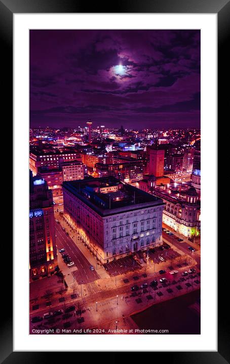 Vertical aerial view of an illuminated historic building at night with city lights in the background in Liverpool, UK. Framed Mounted Print by Man And Life