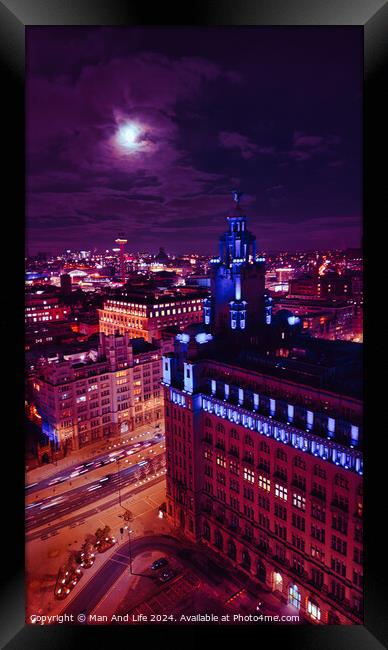 Cityscape at night with illuminated buildings under a moonlit sky in Liverpool, UK. Framed Print by Man And Life
