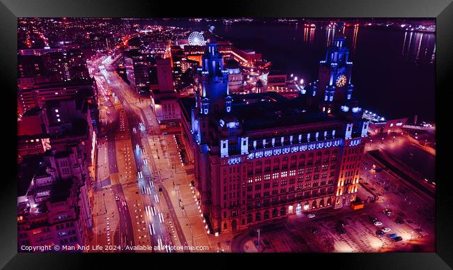 Aerial night view of an illuminated cityscape with a prominent clock tower and urban streets in Liverpool, UK. Framed Print by Man And Life