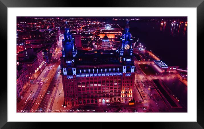 Aerial night view of an illuminated urban cityscape with skyscrapers and a waterfront in Liverpool, UK. Framed Mounted Print by Man And Life