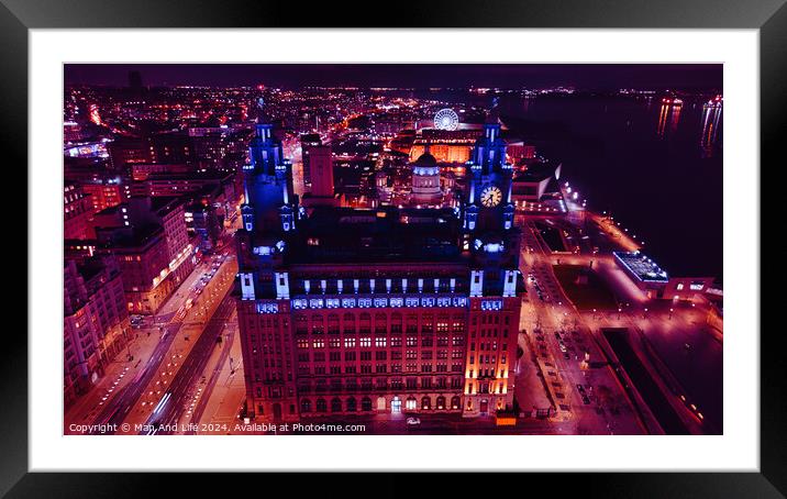 Aerial night view of an illuminated historic building in an urban setting with city lights in the background in Liverpool, UK. Framed Mounted Print by Man And Life