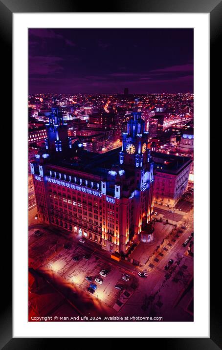 Aerial night view of an illuminated historic building in an urban cityscape with vibrant purple skies in Liverpool, UK. Framed Mounted Print by Man And Life