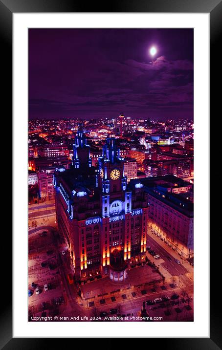 Aerial night view of an illuminated historic building in an urban cityscape with vibrant purple skies in Liverpool, UK. Framed Mounted Print by Man And Life