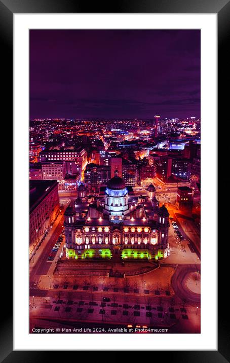 Aerial night view of a cityscape with illuminated buildings and vibrant urban lights in Liverpool, UK. Framed Mounted Print by Man And Life