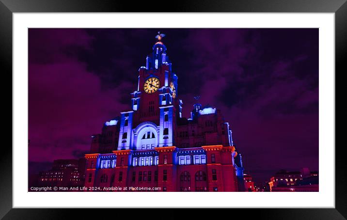 Liverpool's iconic Royal Liver Building at night, illuminated in vibrant purple light against a dark sky. Framed Mounted Print by Man And Life