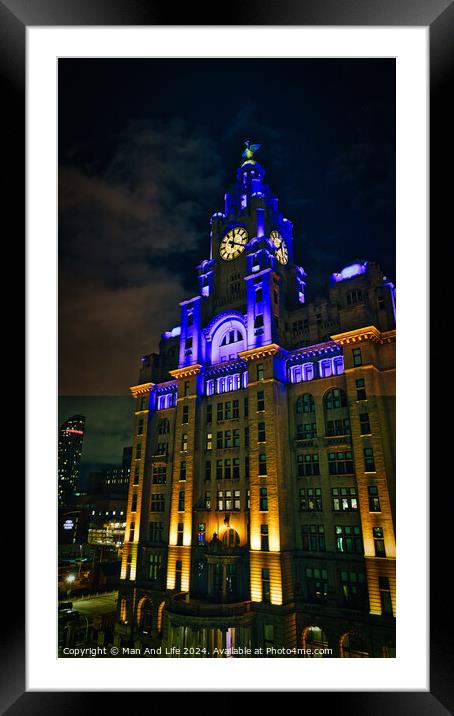 Liverpool's iconic Royal Liver Building at night, illuminated with blue lights against a dark sky. Framed Mounted Print by Man And Life