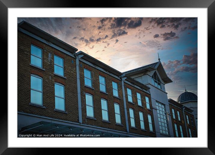 Classic building facade against a dramatic sunset sky with clouds. Framed Mounted Print by Man And Life