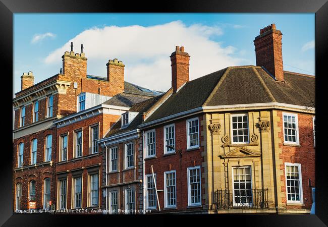 Historic brick buildings with classic British architecture under a clear blue sky in York, UK. Framed Print by Man And Life