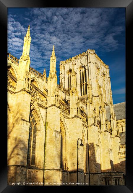 Gothic cathedral facade with spires against a clear blue sky at sunset, showcasing historical architecture in York, UK. Framed Print by Man And Life