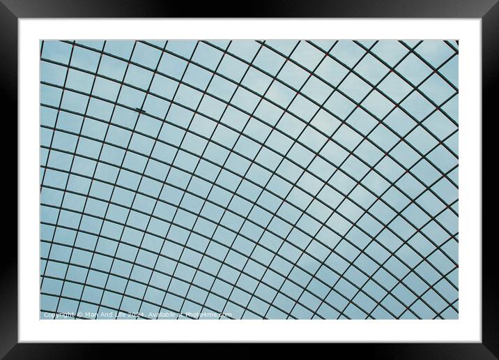 Abstract geometric pattern of a glass ceiling against a clear blue sky. Framed Mounted Print by Man And Life