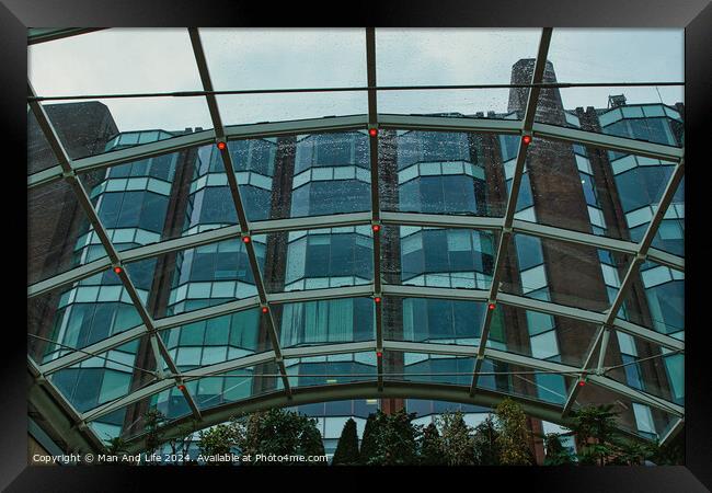 Modern glass building facade viewed through a transparent arched ceiling, showcasing urban architecture in Leeds, UK. Framed Print by Man And Life