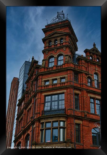 Victorian red brick building with ornate architecture against a dramatic cloudy sky, showcasing a contrast of historical and modern urban design in Leeds, UK. Framed Print by Man And Life
