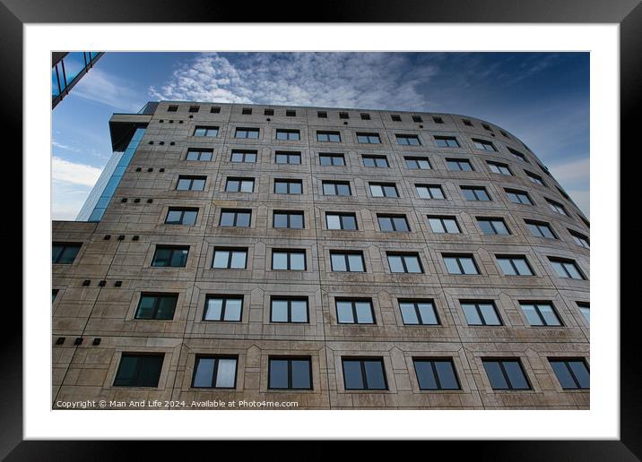 Modern office building facade with geometric windows against a clear blue sky in Leeds, UK. Framed Mounted Print by Man And Life
