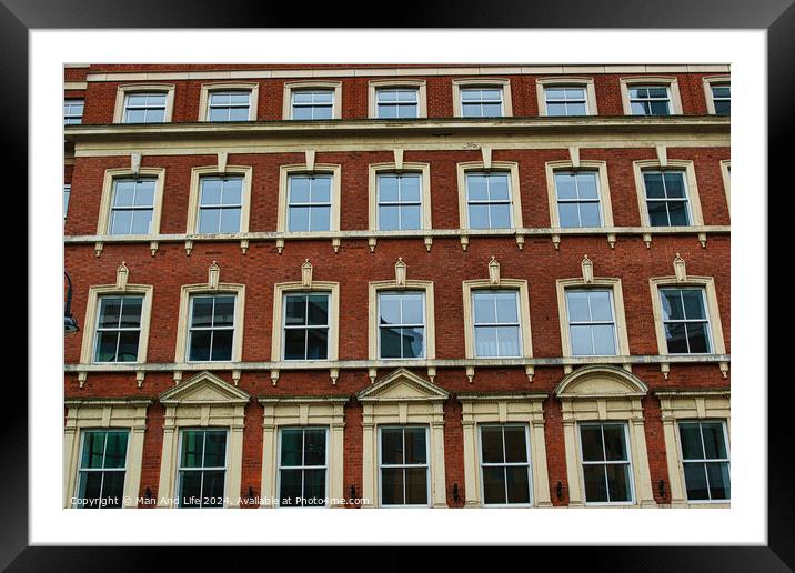 Facade of a classic red brick building with symmetrical windows against a clear sky in Leeds, UK. Framed Mounted Print by Man And Life