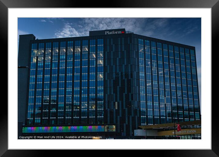 Modern office building facade with reflective glass windows against a clear blue sky in Leeds, UK. Framed Mounted Print by Man And Life