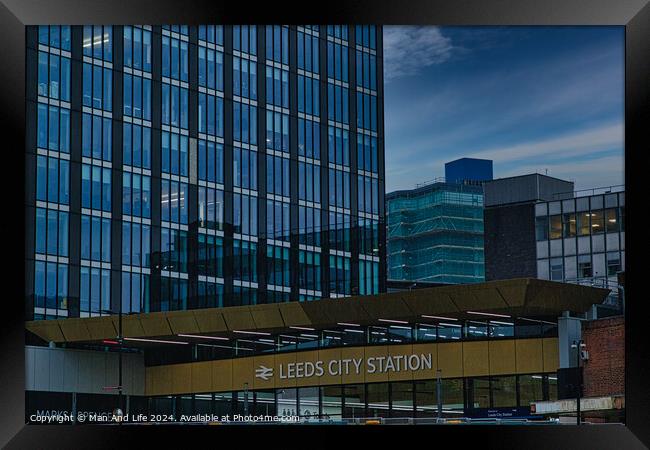 Exterior view of Leeds City Station with modern architecture and signage, under a cloudy sky Framed Print by Man And Life
