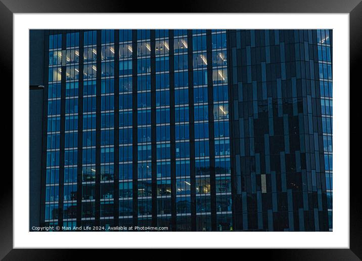 Modern office building facade with reflective glass windows at dusk in Leeds, UK. Framed Mounted Print by Man And Life