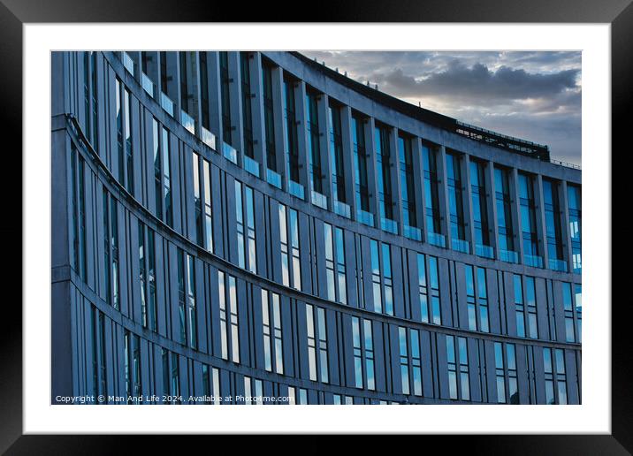 Modern office building facade with reflective glass windows against a cloudy sky at dusk in Liverpool, UK. Framed Mounted Print by Man And Life