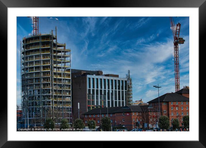 Urban construction site with cranes and developing high-rise building against a blue sky with wispy clouds in Liverpool, UK. Framed Mounted Print by Man And Life