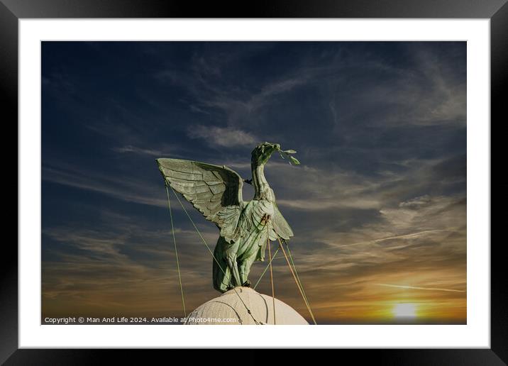 Bronze statue of an angel with outstretched wings against a vibrant sunset sky in Liverpool, UK. Framed Mounted Print by Man And Life