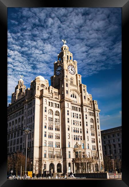 Historic clock tower building against a blue sky with clouds in Liverpool, UK. Framed Print by Man And Life
