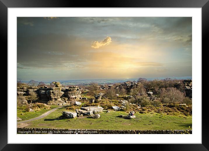 Picturesque rural landscape at sunset with rocky formations and green fields under a cloudy sky at Brimham Rocks, in North Yorkshire Framed Mounted Print by Man And Life