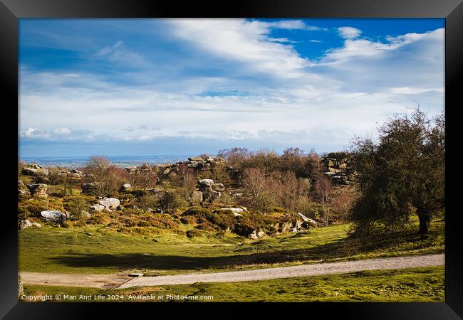 Idyllic rural landscape with lush green fields, scattered trees, and a clear blue sky with fluffy clouds at Brimham Rocks, in North Yorkshire Framed Print by Man And Life