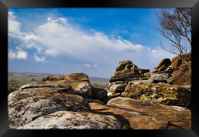 Scenic view of rugged rocks against a blue sky with fluffy clouds, highlighting the natural beauty of a mountainous landscape at Brimham Rocks, in North Yorkshire Framed Print by Man And Life