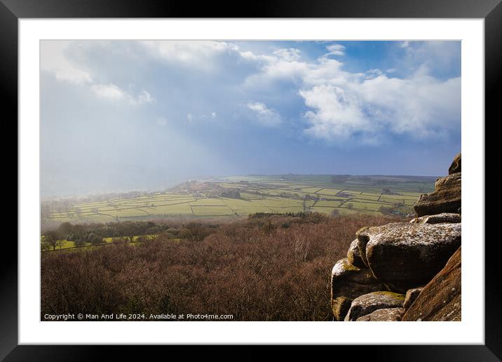 Scenic view of a sunlit countryside landscape with rocky foreground under a dramatic sky at Brimham Rocks, in North Yorkshire Framed Mounted Print by Man And Life