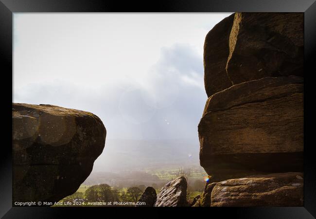 Scenic view of a landscape through rock formations under a cloudy sky at Brimham Rocks, in North Yorkshire Framed Print by Man And Life