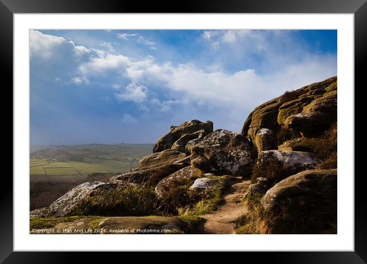 Majestic rocky landscape with sunlit grass under a blue sky with clouds at Brimham Rocks, in North Yorkshire Framed Mounted Print by Man And Life