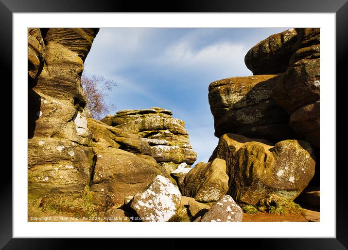 Scenic view of weathered rock formations under a blue sky with clouds at Brimham Rocks, in North Yorkshire Framed Mounted Print by Man And Life