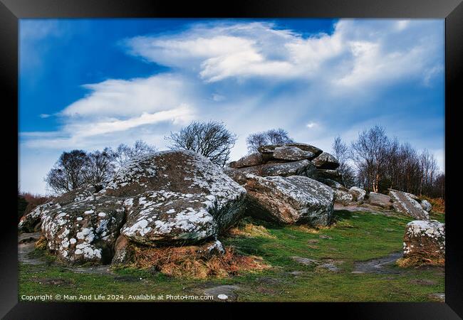 Rugged landscape with moss-covered rocks under a cloudy sky at Brimham Rocks, in North Yorkshire Framed Print by Man And Life