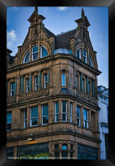 Victorian architecture with ornate details on a historic building's facade against a blue sky in Leeds, UK. Framed Print by Man And Life