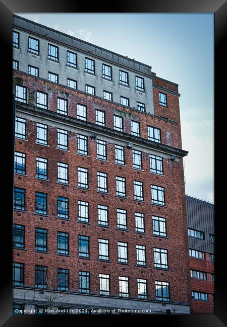 Facade of a modern red brick building against a clear blue sky, showcasing urban architecture in Leeds, UK. Framed Print by Man And Life